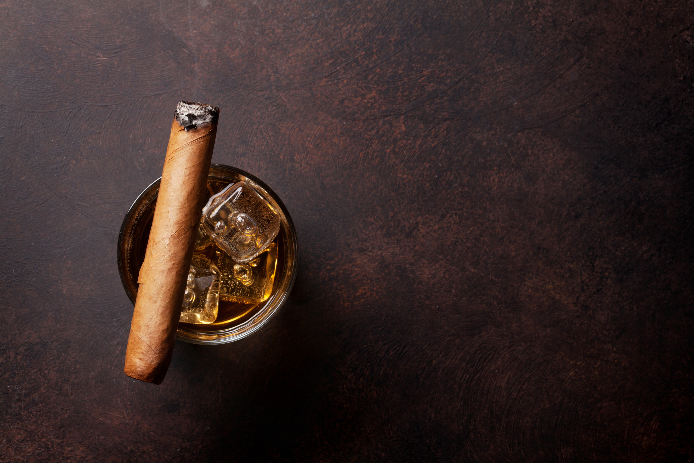 Whiskey with ice and cigar